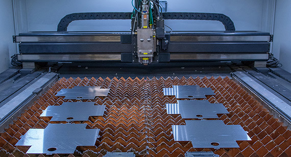 Production run of custom laser cut stainless steel parts for institutional client